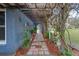 Arched walkway filled with decor and greenery that leads to an inviting entrance at 1102 N Palmetto St, Leesburg, FL 34748