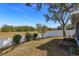 Manicured backyard with a white fence and a view of mature trees in the distance at 1123 Bluegrass Dr, Groveland, FL 34736