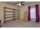 Bedroom with a ceiling fan, wire shelves, and a filing cabinet at 1123 Bluegrass Dr, Groveland, FL 34736