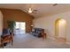 Cozy living room with vaulted ceilings, fan, and sliding doors to the outdoor space at 1123 Bluegrass Dr, Groveland, FL 34736