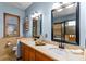 Bathroom showcasing double sinks, modern fixtures, and a view of the soaking tub at 11325 Michael John Rd, Howey In The Hills, FL 34737