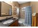 Well-lit bathroom featuring granite counters, warm tones, and decorative towel storage at 11325 Michael John Rd, Howey In The Hills, FL 34737