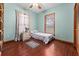 Cozy bedroom with natural light, ceiling fan, and laminate floors at 11325 Michael John Rd, Howey In The Hills, FL 34737