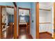 Hallway view into the bedroom featuring wood floors and access to the ensuite bathroom and closet at 11325 Michael John Rd, Howey In The Hills, FL 34737