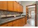 View of the kitchen's wooden cabinets and countertop space, with a pantry and doorway in the background at 11325 Michael John Rd, Howey In The Hills, FL 34737