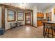 Open kitchen featuring tiled floors, ample wooden cabinetry, and rustic wooden beam accents at 11325 Michael John Rd, Howey In The Hills, FL 34737