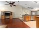 Open living room and kitchen area with bar and natural light at 11325 Michael John Rd, Howey In The Hills, FL 34737