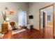 Charming corner of the main bedroom featuring wood floors, soft lighting, and a TV at 11325 Michael John Rd, Howey In The Hills, FL 34737