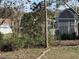 Partially overgrown backyard with mature trees at 11425 Alameda Sandra Dr, Clermont, FL 34711