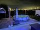 Nighttime view of above ground pool with umbrella, patio and trailer at 119 Cory Ct, Auburndale, FL 33823
