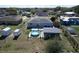 Aerial view of backyard with storage sheds, above ground pool, and a covered patio at 119 Cory Ct, Auburndale, FL 33823