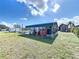 The backyard features a carport and shed, offering practical spaces for projects and storage at 119 Cory Ct, Auburndale, FL 33823
