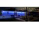 Nighttime view of backyard with pool, patio furniture and tasteful blue lighting at 119 Cory Ct, Auburndale, FL 33823