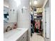 Bathroom features a walk-in closet, modern vanity and neutral tile at 119 Cory Ct, Auburndale, FL 33823