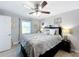 Serene bedroom with ceiling fan, a comfortable bed, and ample natural light at 119 Cory Ct, Auburndale, FL 33823
