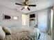 Bedroom with neutral decor, ceiling fan and a large window at 119 Cory Ct, Auburndale, FL 33823