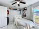 Bedroom features white floors, ceiling fan and view to the backyard at 119 Cory Ct, Auburndale, FL 33823