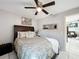 Bedroom with neutral decor, ceiling fan, and a large window at 119 Cory Ct, Auburndale, FL 33823