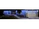 Well lit house exterior at night with landscaping, path, and white garage door at 119 Cory Ct, Auburndale, FL 33823