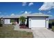 Charming single-story home with a well-maintained yard, driveway, and two-car garage at 119 Cory Ct, Auburndale, FL 33823