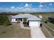 Charming single-story home with a well-maintained yard, driveway, and two-car garage at 119 Cory Ct, Auburndale, FL 33823