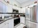 Cozy kitchen with white cabinets, stainless appliances, and ample counter space at 119 Cory Ct, Auburndale, FL 33823