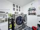 This laundry room features modern washer and dryer, complemented by stylish decor at 119 Cory Ct, Auburndale, FL 33823