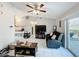 Bright living room featuring tile floors, a ceiling fan, and access to the patio at 119 Cory Ct, Auburndale, FL 33823