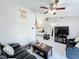 Inviting living room with neutral tones, tile flooring, and contemporary furnishings at 119 Cory Ct, Auburndale, FL 33823