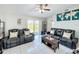 Well-lit living room with modern furniture, tile flooring, and sliding glass doors at 119 Cory Ct, Auburndale, FL 33823