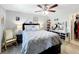 Comfortable main bedroom with a ceiling fan, rocker, and vanity at 119 Cory Ct, Auburndale, FL 33823