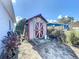 This property features a shed for storage, with a clean and organized exterior at 119 Cory Ct, Auburndale, FL 33823