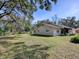 Spacious backyard with large trees, providing ample space for relaxation and outdoor activities at 11915 Cr 680, Webster, FL 33597