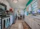 Bright kitchen featuring stainless steel appliances, white cabinets, and an adjacent dining area at 11915 Cr 680, Webster, FL 33597