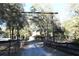 Long driveway leading to a charming country home, surrounded by lush trees at 1205 Darcy Rd, Lady Lake, FL 32159