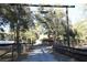 View of home on acreage with a gated entrance and mature shade trees at 1205 Darcy Rd, Lady Lake, FL 32159