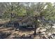 Aerial view of a cozy home surrounded by mature trees and picnic tables at 1205 Darcy Rd, Lady Lake, FL 32159