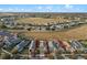 Aerial view of the property and surrounding neighborhood, backing up to a wide open green space at 123 Bayou Bend Rd, Groveland, FL 34736