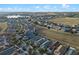 An aerial view of a neighborhood backing up to a large green space in a sprawling community at 123 Bayou Bend Rd, Groveland, FL 34736