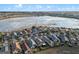 An aerial view of a lakeside community with well-maintained homes, landscaping, and water views at 123 Bayou Bend Rd, Groveland, FL 34736