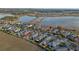 An aerial view of a community near a scenic lake, showcasing homes with landscaping and outdoor spaces at 123 Bayou Bend Rd, Groveland, FL 34736