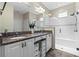 Elegant bathroom with double vanity, granite countertop, and a glass-enclosed shower at 123 Bayou Bend Rd, Groveland, FL 34736