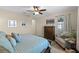 Cozy bedroom featuring a ceiling fan, soft lighting, and comfortable furnishings, creating a relaxing retreat at 123 Bayou Bend Rd, Groveland, FL 34736