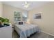 Well-lit bedroom with a comfortable bed, neutral tones, and ample natural light at 123 Bayou Bend Rd, Groveland, FL 34736