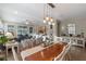 A dining room with a wooden table, chairs, and pendant lighting, connecting seamlessly to the living area and kitchen at 123 Bayou Bend Rd, Groveland, FL 34736