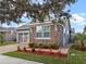 Charming home with a two-car garage, stone accents, complemented by brick pavers and colorful landscaping at 123 Bayou Bend Rd, Groveland, FL 34736