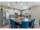 A kitchen boasts a granite island with seating, stainless steel appliances, and bright cabinetry, creating a functional and stylish space at 123 Bayou Bend Rd, Groveland, FL 34736