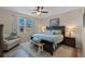 A tranquil main bedroom featuring soft carpeting, ample natural light, and tastefully coordinated decor, with a view of the outdoors at 123 Bayou Bend Rd, Groveland, FL 34736