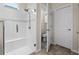 Modern walk-in shower with white tile, a built-in bench, and a glass door at 123 Bayou Bend Rd, Groveland, FL 34736