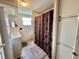 Bathroom featuring a vanity with sink, toilet, a patterned shower curtain, and ample storage space at 133 Hibiscus Way, Leesburg, FL 34748